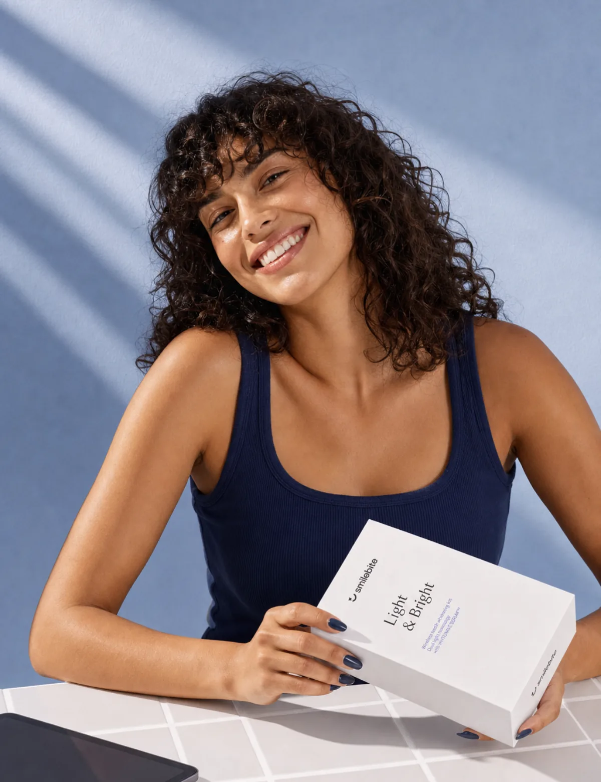 Woman holding the Smilebite Light & Bright packaging